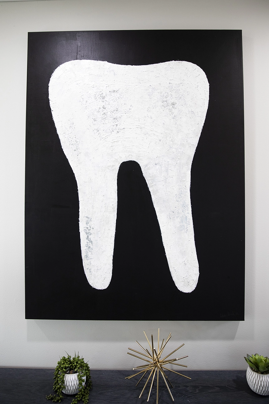 A white tooth on black canvas by Dr. Ahmed