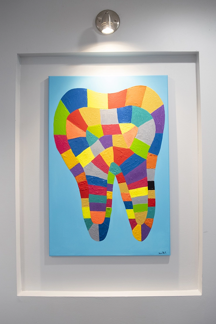 Painting of a multi-colored tooth by Dr. Ahmed
